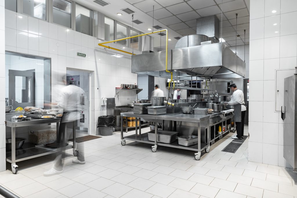 A clean, organized commercial kitchen prepared for a health and safety inspection.