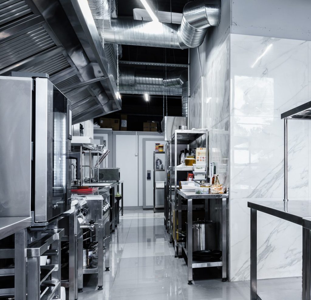 Stainless steel commercial kitchen with cooking equipment